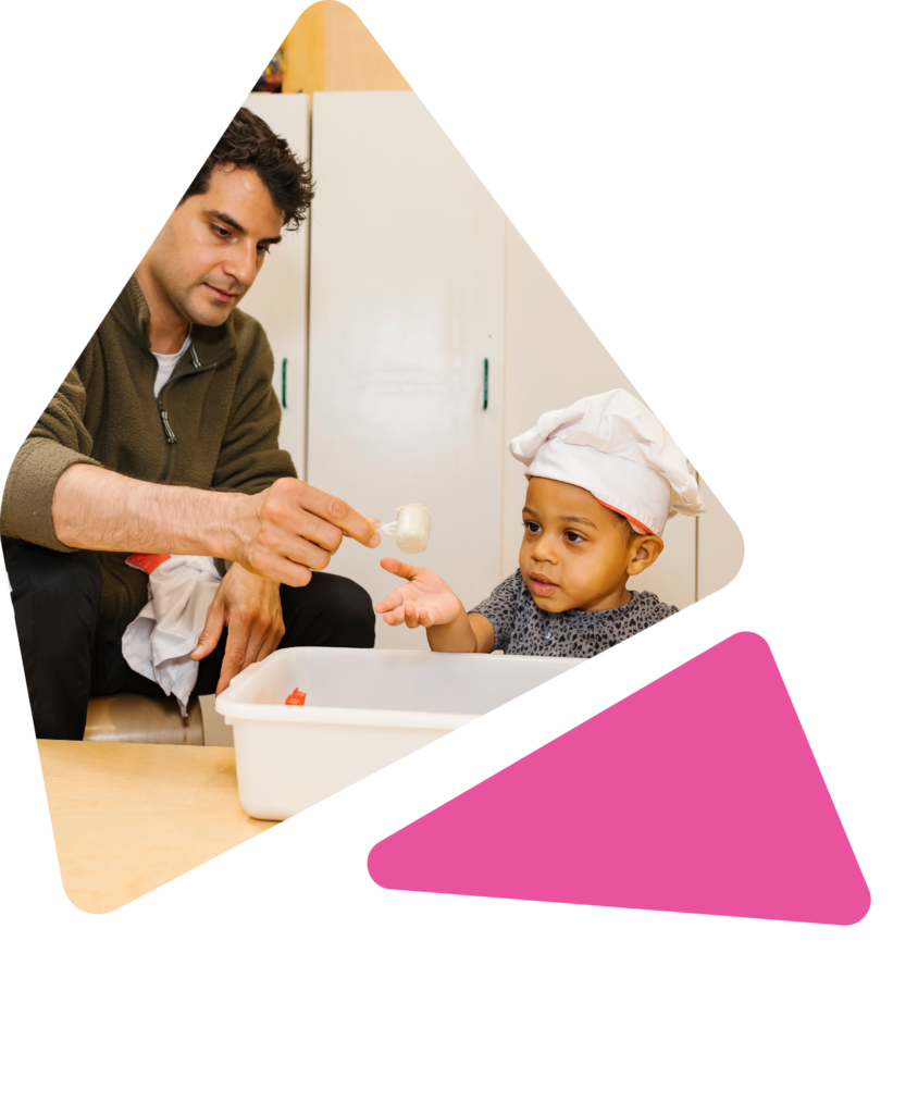 teacher and child interacting at craft table