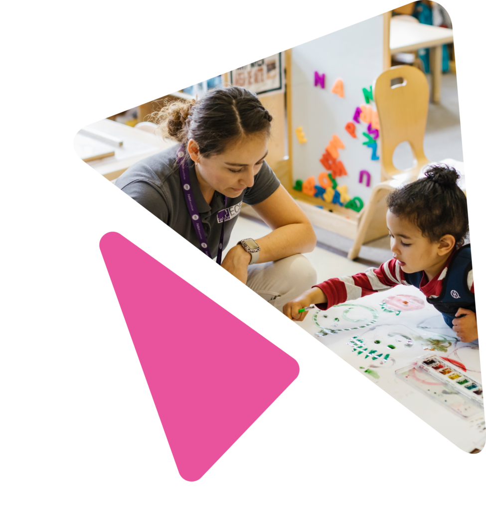 teacher playing with child at craft table