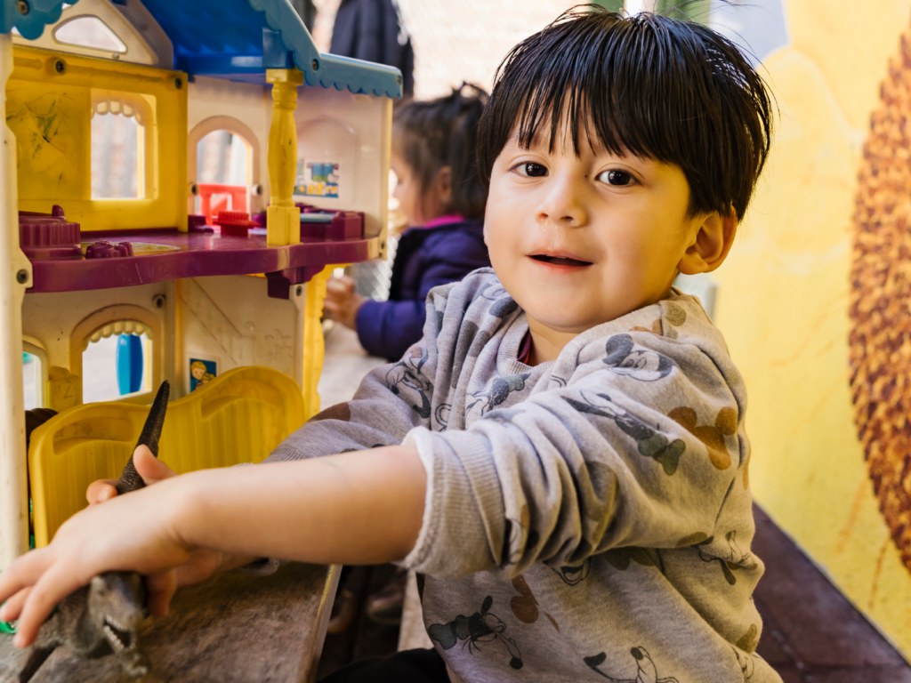 child playing with toys at table
